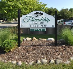 beautiful front view of the friendship manor sign and property